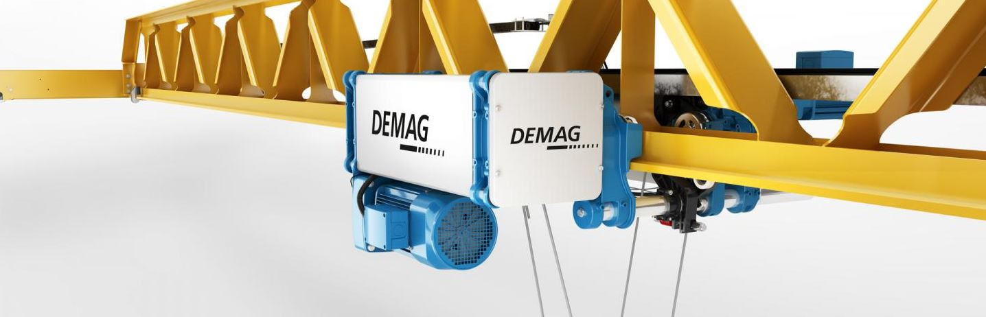 Demag hoist in blue and grey suspended from a yellow metal girder