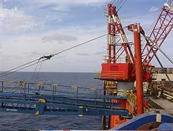 A photo of an oil rig offshore in the sea, a close up of the boon 